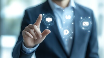 A businessman's hand reaching out to a glowing circle of communication icons.