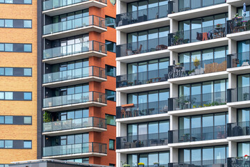 Several residential buildings featuring colorful facades with balconies and a modern design, situated in a vibrant urban environment in Rotterdam