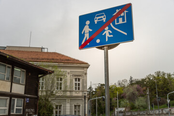 Blue sign with a red cross on it that says "No children allowed."