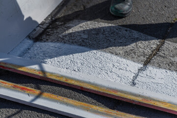 Person is painting a sidewalk with a white paint