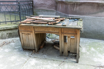 Wooden desk with a broken top and a hole in the middle