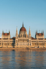 hungarian parliament building from across the river with blue sky 