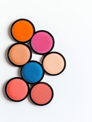 A vibrant collection of colorful cosmetic blushes arranged artistically on a light background.