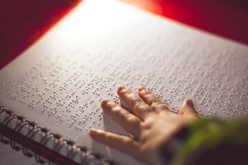 reading a Braille book in the dark for blind and visually impaired people