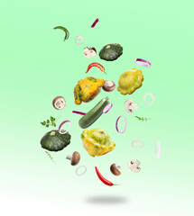 Many different fresh vegetables in air on light green background