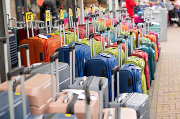 Different colored suitcases at a market stall. Luggage, trolley for vacation and business trips. Haagse Market in The Hague, Netherlands.