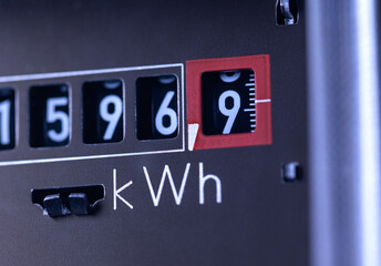 Close-up power consumption, analog electricity meter in the basement. Measuring used electricity in kWh ( kilowatt hour )