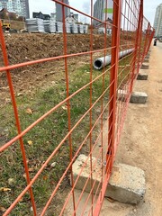 Fototapeta premium construction, building materials stacked behind the fence 