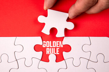 Golden Rule. White puzzle pieces on an red background