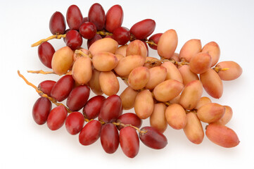 three red pink dates bunch on white background