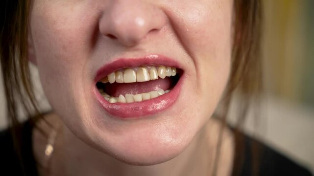 Close up woman open mouth with teeth, jaw movement. Detailed shot female open mouth, showing teeth and jaw motion. Woman lips with visible teeth and jaw movement