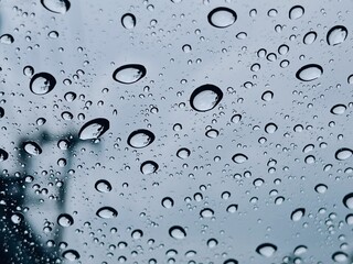 Rain on the windshield while traffic jams, Water droplets on the glass on a natural background.