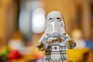 Fototapeta premium Lego brand Star Wars snowtrooper toy figurine with helmet and handcuffs on a blurred background