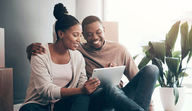 Relax, moving and black couple in new house with tablet, planning and online interior design ideas. Smile, man and happy woman on floor with boxes, hug and digital app for inspiration in home decor - Powered by Adobe