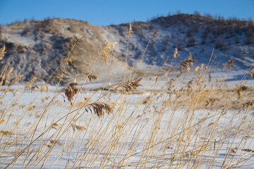 Winter landscape, beautiful view of the frozen lake and the mountains around it Lake Baikal in Russia