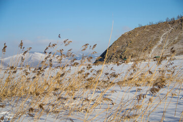 Obraz premium Winter landscape, beautiful view of the frozen lake and the mountains around it Lake Baikal in Russia