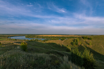 Naklejka premium A beautiful landscape with a river and a hillside