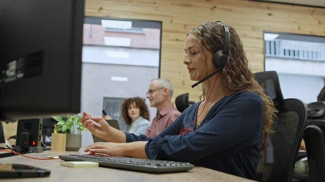 Customer service representative working at her desk - business concept