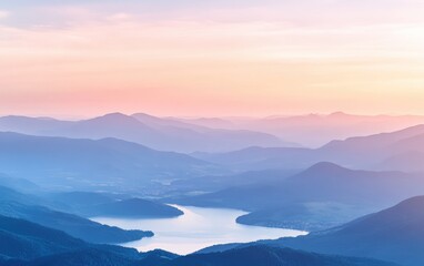 Obraz premium Sunset over mountains with a lake in the foreground, soft pastel colors in the sky. 
