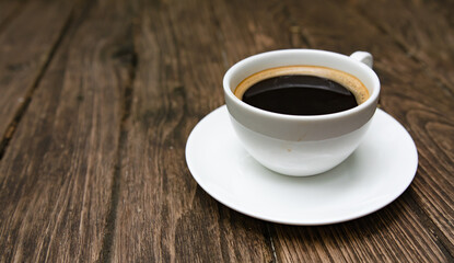 Cup of aromatic coffee on wooden table. Space for text