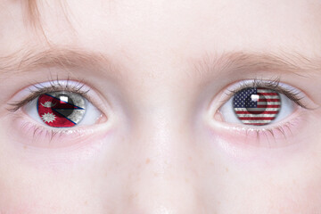Naklejka premium human face with national flags of nepal and united states of america in the eyes.
