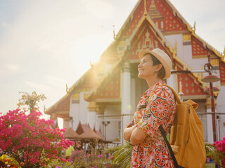 Travel to Ayutthaya, Thailand. Young female tourist explores modern Buddhist temples, surrounded by vibrant architecture and cultural symbols, capturing essence of spirituality and Thai heritage.