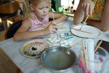  A young mother and her daughter enjoy a creative art session at home 