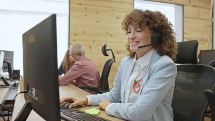 Businesswoman working with headset in busy office - business concept