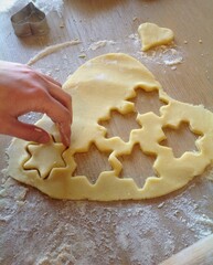 Pastry chef removing star shaped cookies from dough