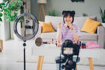 Photo of adorable sweet lady wear violet striped t-shirt recording beauty video modern device...
