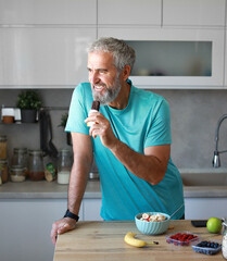 kitchen food man healthy morning breakfast active fitness diet bar snack protein  mature energy chocolate home healthy eating senior adult