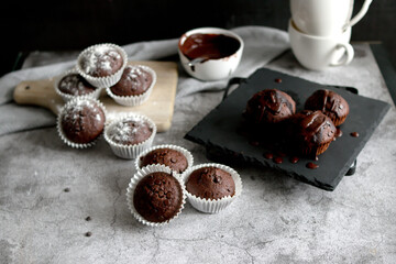 
chocolate cupcakes with chocolate chips.on a gray table.dessert