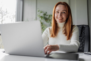 Woman Working at Laptop in Modern Office