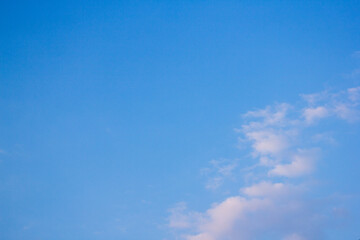 a beach with a few people on it and a sailboat in the distance.