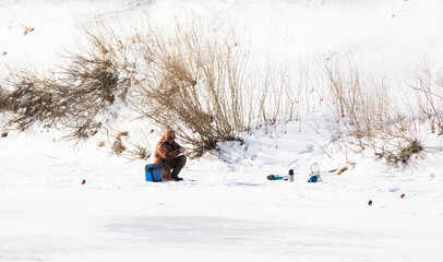 The fisherman on winter fishing fishes