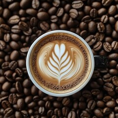 A close-up of a coffee cup sitting on dark roasted coffee beans.