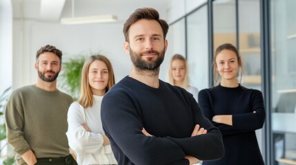 Obraz premium A group of five individuals stands proudly in a well-lit office, showcasing teamwork and professionalism in a modern corporate setting, emphasizing collaboration and unity