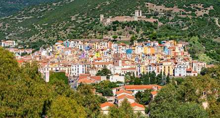 Fototapeta premium Panoramic view of the colorful buildings of Bosa and the Castle of Serravalle. Oristano, Sardinia, Italy