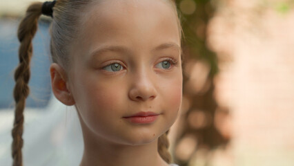 Close up portrait adorable cute happy smiling Caucasian little girl child kid schoolgirl pupil...