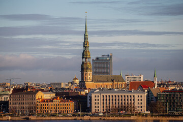 Obraz premium Riga, Latvia city skyline in late 2024 with could and warm light of river Daugava and buildings in city center and old town 