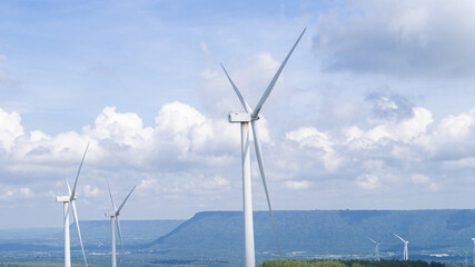 Wind turbines produce electricity using the power of natural winds high in the mountains. Wind farms for producing green renewable energy. To preserve the environmental
