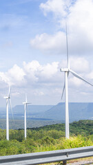 Windmill on a high green mountain hill Surrounded by trees For producing electricity from wind for green renewable energy.