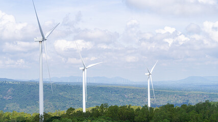 Wind turbines with wind farms at the background Producing clean energy that is still standing on Khao Yai Thiang, Thailand with a sky that has many clouds
