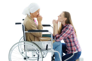 Smiling Caucasian daughter with elderly mother sitting on wheelchair and pray for god together after chemotherapy. Elderly mother is suffering from cancer or Leukemia patient. Clip art and element