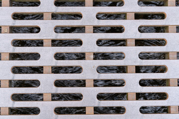 Massive metal lid, like a manhole cover, over a little creek in a street of a city. Clear water is flowing into the system. Cover is used to protect pedestrians from stumbling into the water. 