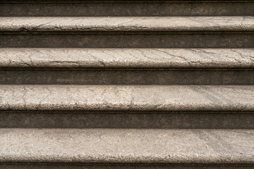 Close up view of outside old fashioned rounded stairs. Stairs are already weathered hand have signs of usage and cracks.