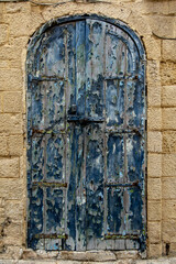 Valletta, Malta  An old weathered door with peeling black paint.