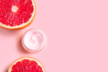 Pink cream moisturizer jar and grapefruit citrus slices