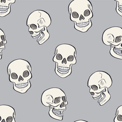 Seamless pattern with hand drawn inky skulls. Skeleton heads repeat background.