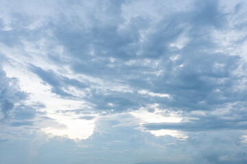 Beautiful fluffy white clouds drift across a bright blue summer sky